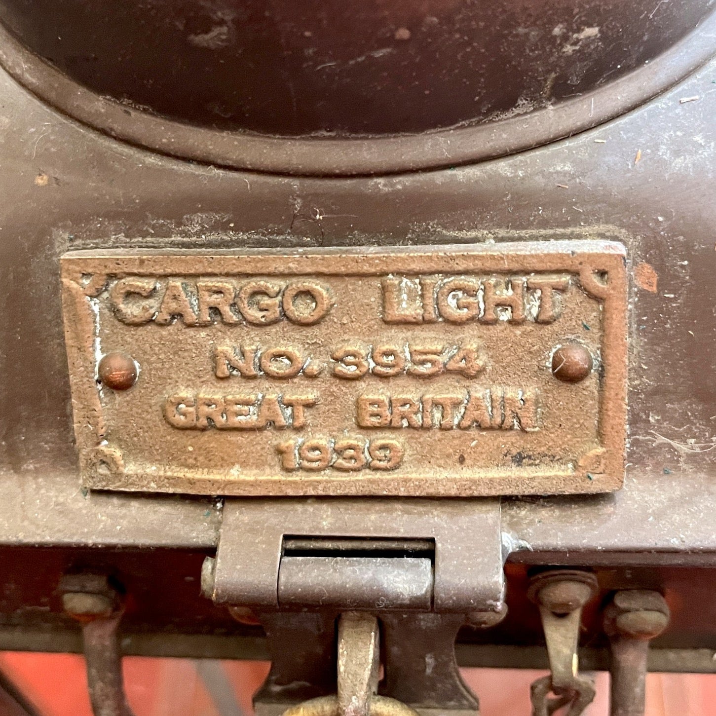 Vintage cargo light with 'Great Britain' label on a red background