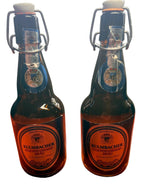 Two Kulmbacher beer bottles on a wooden surface with a blurred background