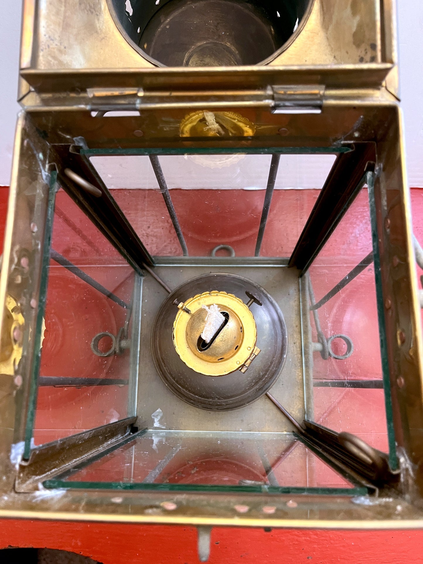 Close-up of a vintage lantern with glass panels and brass frame.