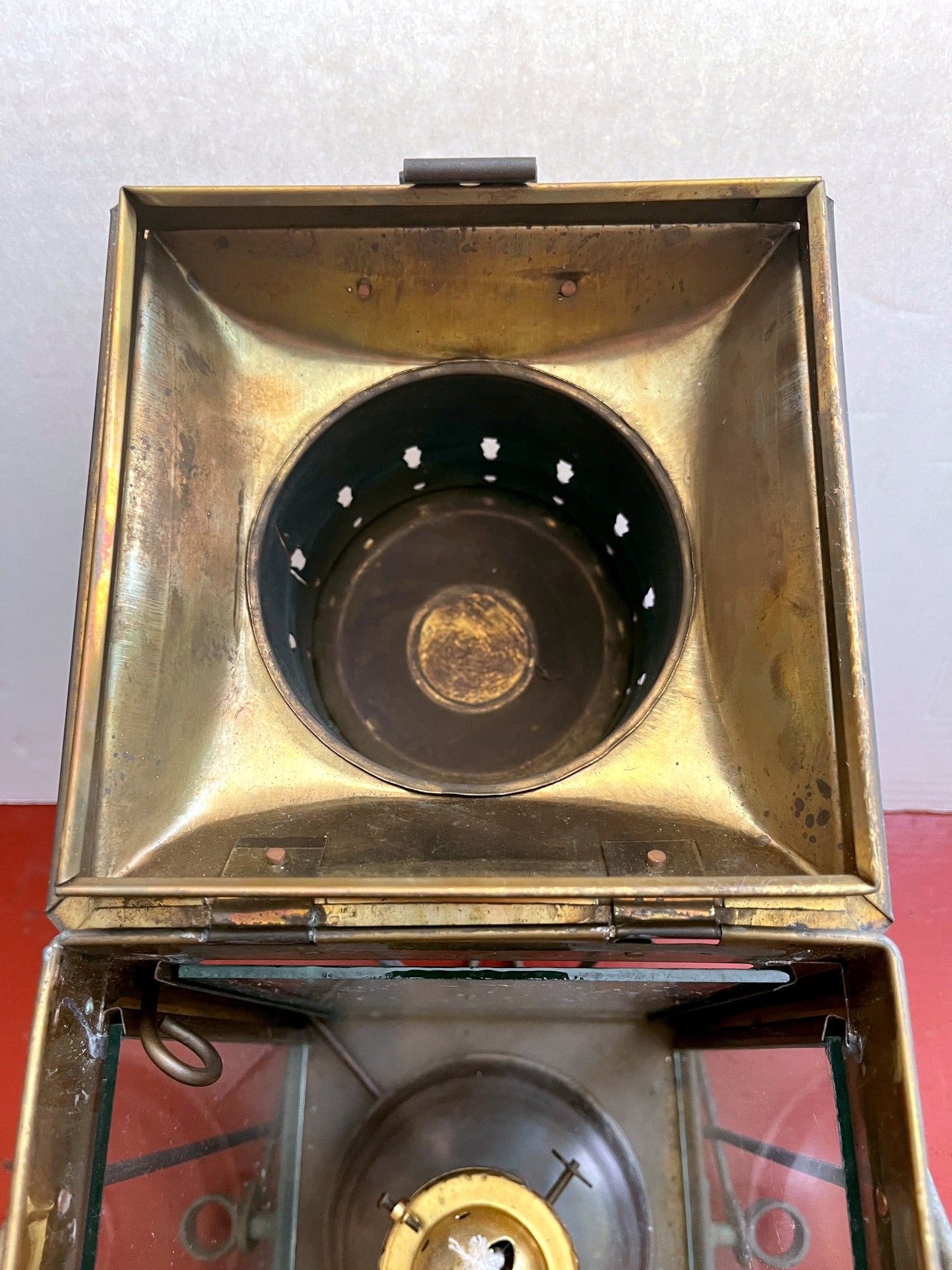 Vintage brass lantern with a black interior on a white background